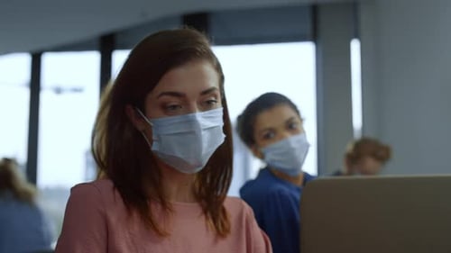 Focused Businesswoman Working Laptop Computer in Medical Mask on Face in Office