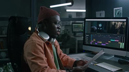 Portrait of African American Male Video Editor Working on Movie in Studio