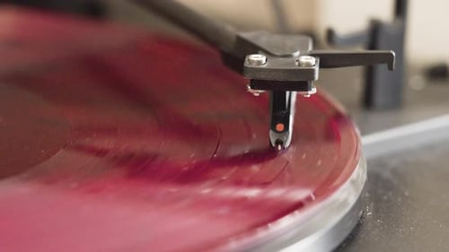 Closeup Shot of a Red Vinyl Record Spinning on a Classic Turntable Player