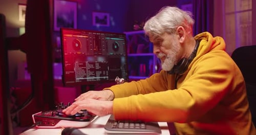 Side View of Happy Caucasian Stylish Pensioner Man Mixing on Vinyl Plates Streaming Music Live