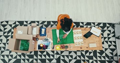 Box, delivery and fashion designer woman wrapping a product in office for courier shipping