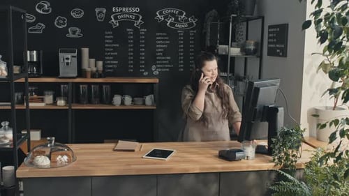 Cafe Worker Having Phone Call
