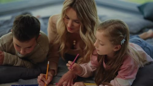 Woman and Children Drawing Together at Home