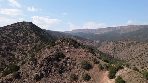 Drone shot of mountain hills and valleys. Aerial view.