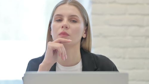 Close Up of Businesswoman Brainstorming while Working on Laptop