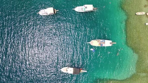 Beautiful view of the beach with boats, pure nature, sea and ships. Shot from a drone.