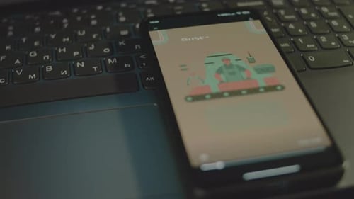 Smartphone Playing Sustainable Manufacturing Video on Laptop