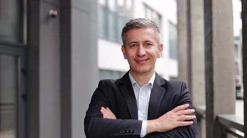 Confident Businessman Smiling in Urban Setting