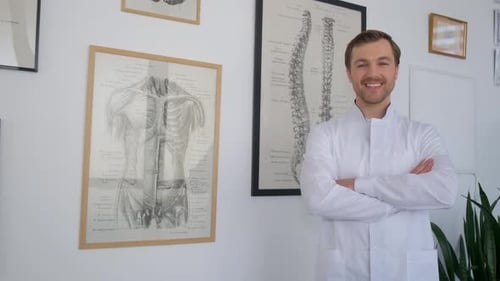 Portrait of a Professional Doctor Standing and Posing for the Camera Smiling in a Medical Center