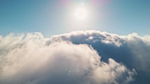 Aerial View of Fluffy Clouds in Sunny Sky