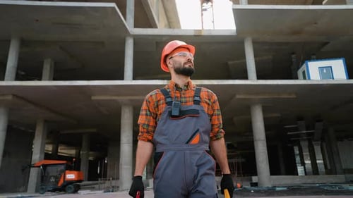Confident Construction Worker Walking on Building Site