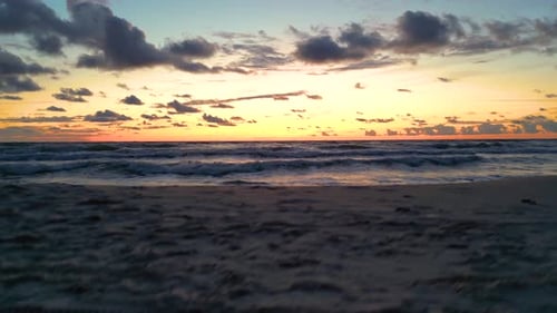 Dramatic sea sunset. Burning sky and shining golden waves. Sunset sea 4k. Red sky, yellow sun and am