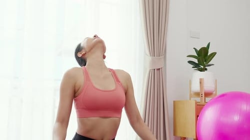 Woman Stretching Neck Indoors During Daytime