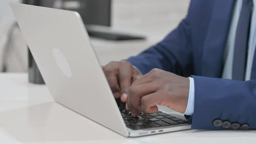 Close-up of Businessman Hands Typing on Laptop