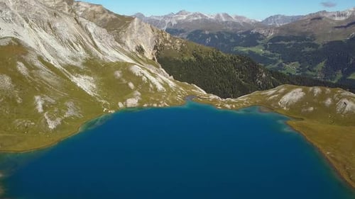 crystal clear blue alpine glacial lake, aerial shot