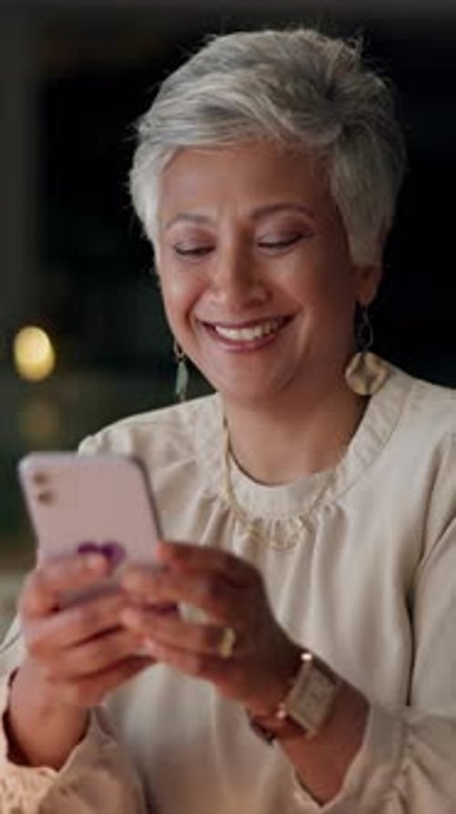 Mature woman, mobile and scroll for internet, website and online application in office at night