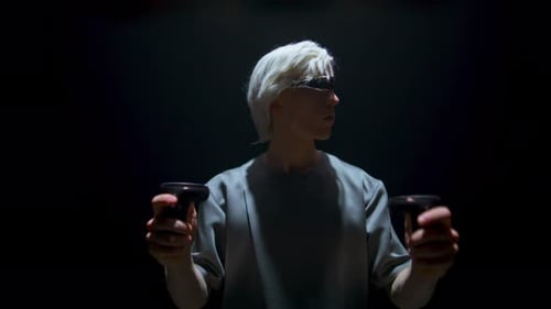 Teenager Using Vr Controllers in Dark Room