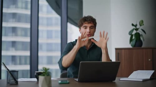 Man On Video Call In Modern Urban Office