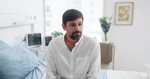 Thinking, patient and man in hospital room, waiting and stress for appointment, anxious and illness