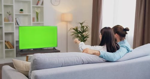 Couple Relaxing Together at Home with Green Screen TV