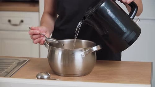 Pouring Hot Water Into Pot with Rice Unrecognizable Person Adding Boiling Liquid Into Saucepan