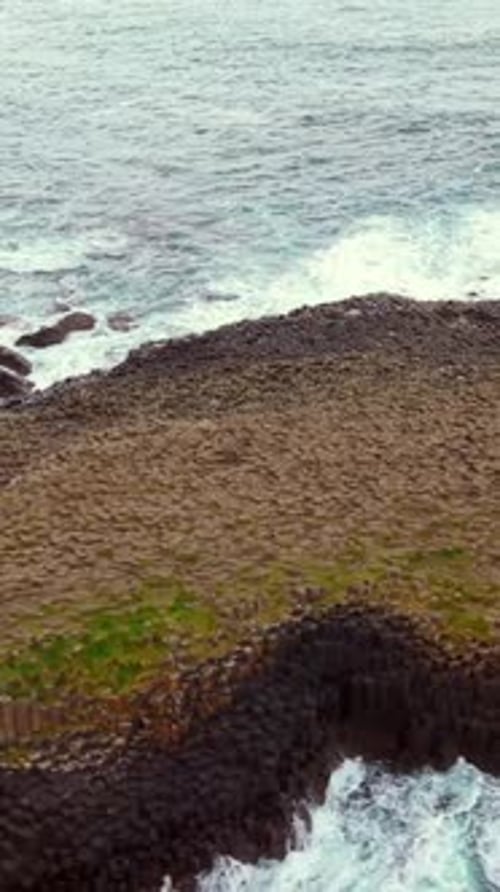 Left-to-right social ratio aerial video of The Giant's Causeway in Bushmills, Northern Ireland, UK
