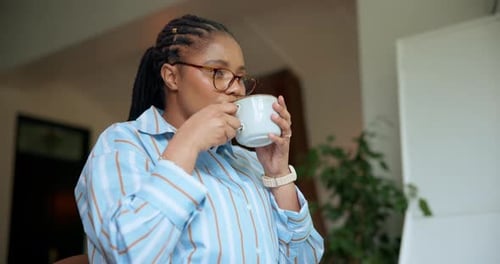 Woman Enjoying Coffee at Home During the Day