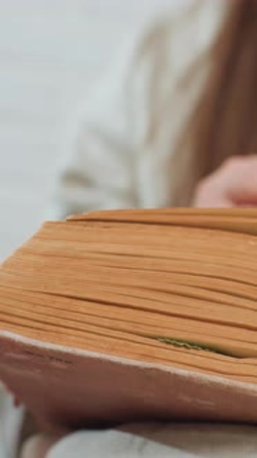 Turning pages of an old weathered book