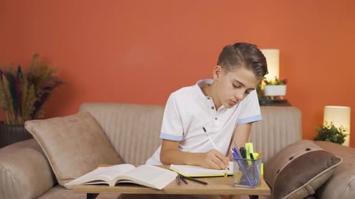 Unhappy and sad boy is bored of reading.