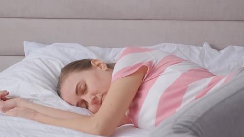 Woman Sleeping Peacefully in Bed at Home