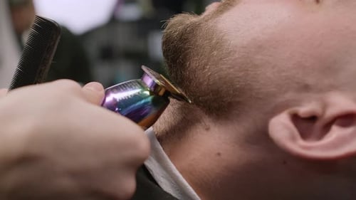 Barber Trimming Beard with Clippers Close Up
