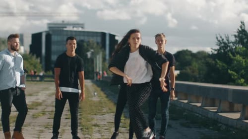 Young Woman Dancing with Group of Young Men