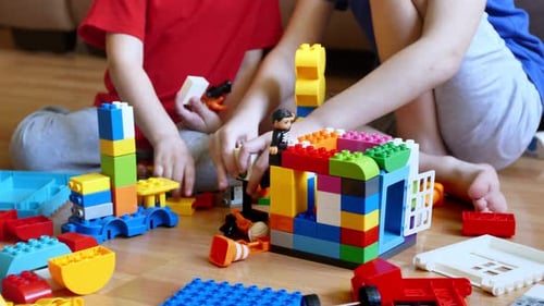 Children Playing with Colorful Building Blocks at Home