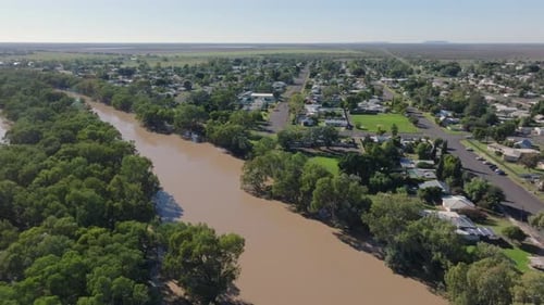 Aerial: Drone circling the overflowing Darling River running past Bourke, NSW Australia