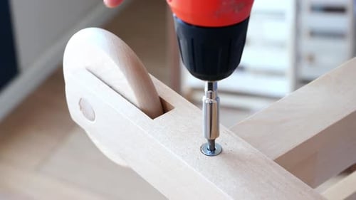 A CloseUp View of an Electric Screwdriver That Is Used in Various Wooden Assembly Projects