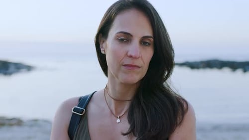 Woman confident, face and natural while outdoors during the day during sunset at beach
