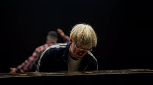 Piano Player Performing with Dancer in Dark Studio