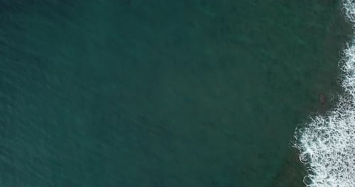 Drone flying over ocean towards waves in Hawaii