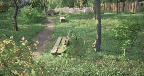 Lush Green Park Area with Benches and Paths Surrounded By Trees and Plants