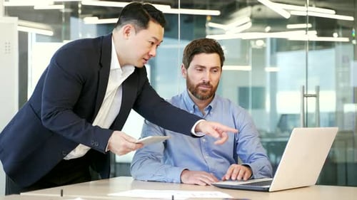 Two Men Collaborating at a Modern Office Workplace