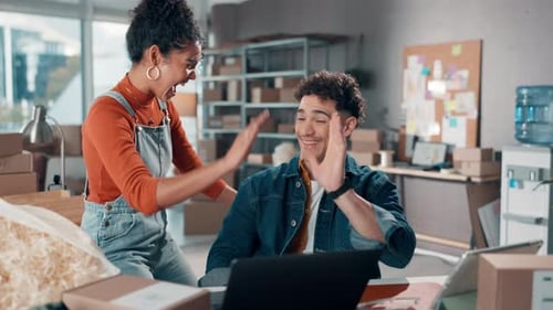Young Adults Celebrate Startup Success in Office