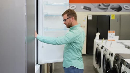 A Man is Viewing Fridge in Home Appliances Store
