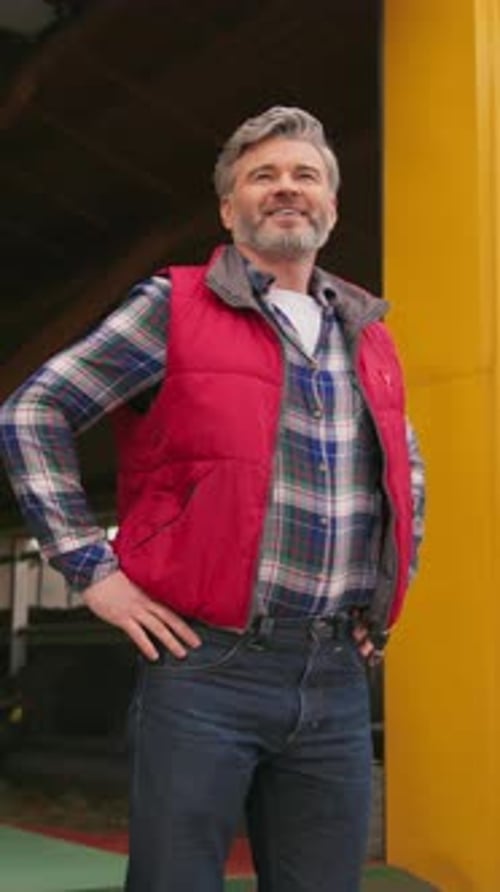 Smiling Man Standing Inside Farm Building
