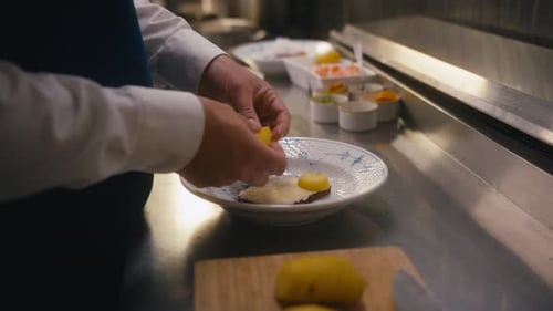 Chef Plating Food in a Professional Kitchen