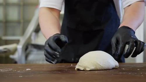 Baking Process in a Bakery a Baker Mixing Kneading and Forming Bread Dough