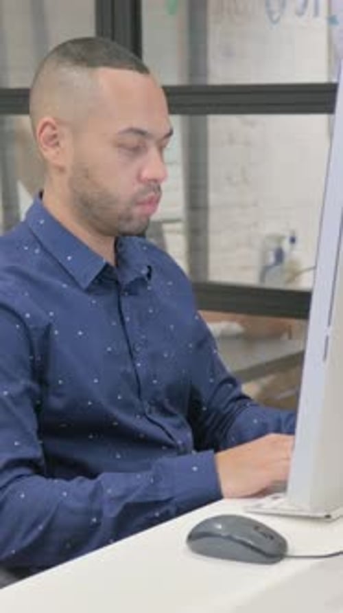 Hispanic Businessman Working on Desktop in Office, vertical video