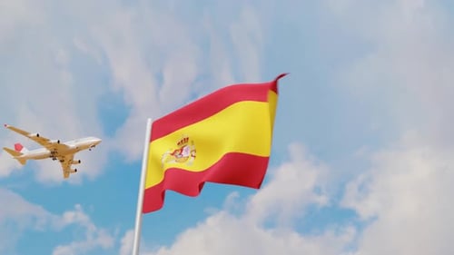 Airplane flying over Spanish Flag waving in sky