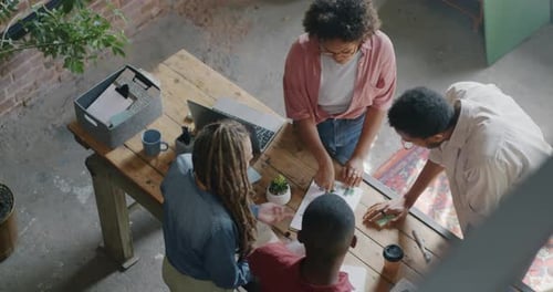 High Angle View of Men and Women Creative Team Working Problem Solving Talking in Loft Style Office