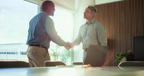 Business Meeting: Men Shake Hands in Bright Office