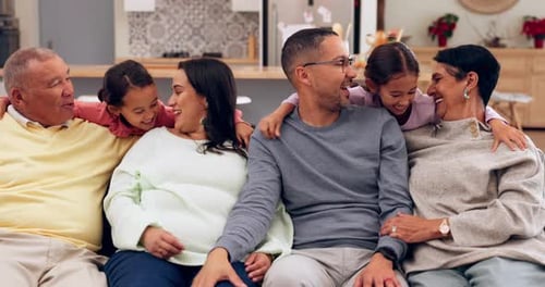 Loving Multi-Generational Family Smiling Together on Sofa